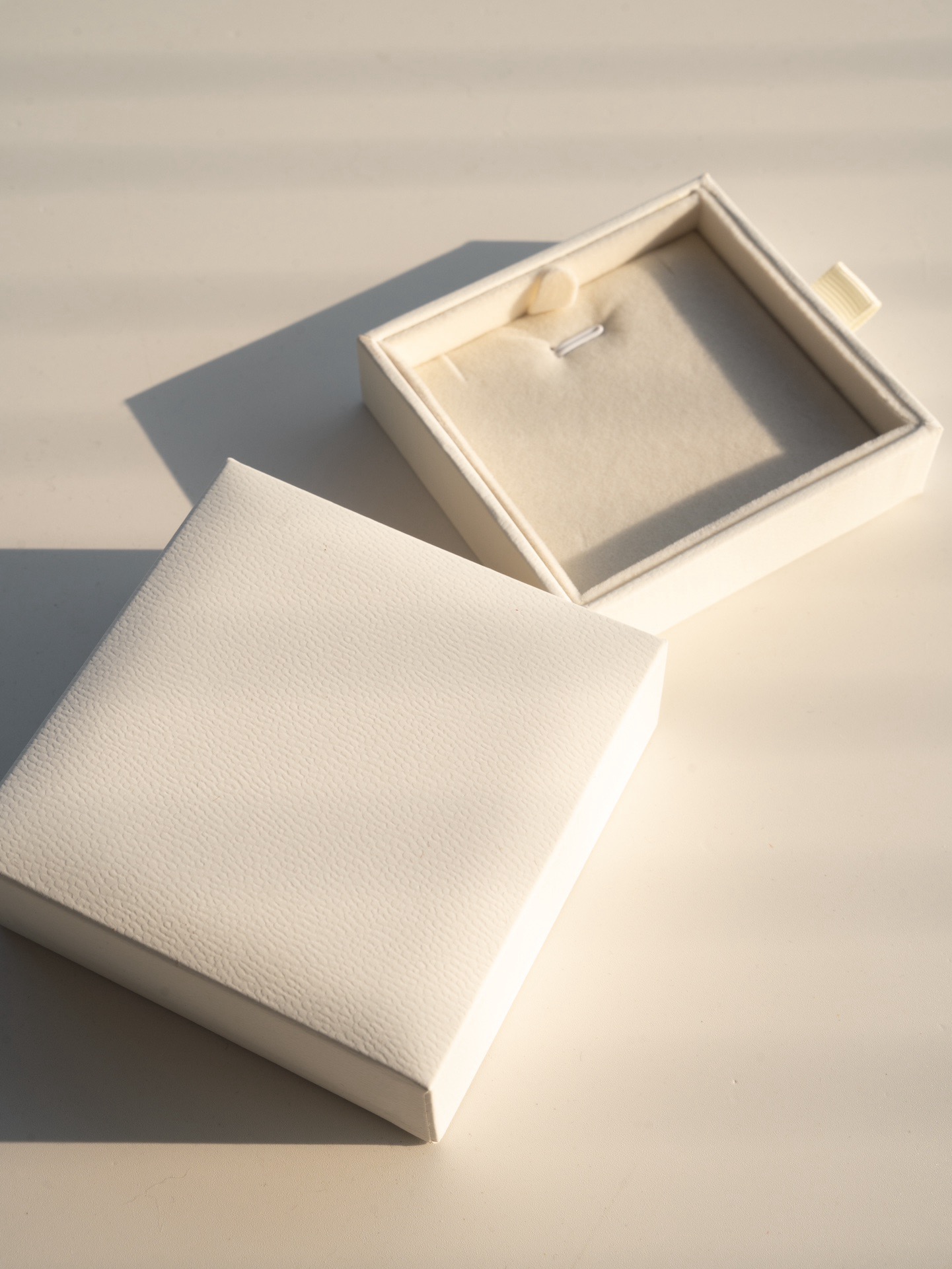 White jewellery box with earrings inside